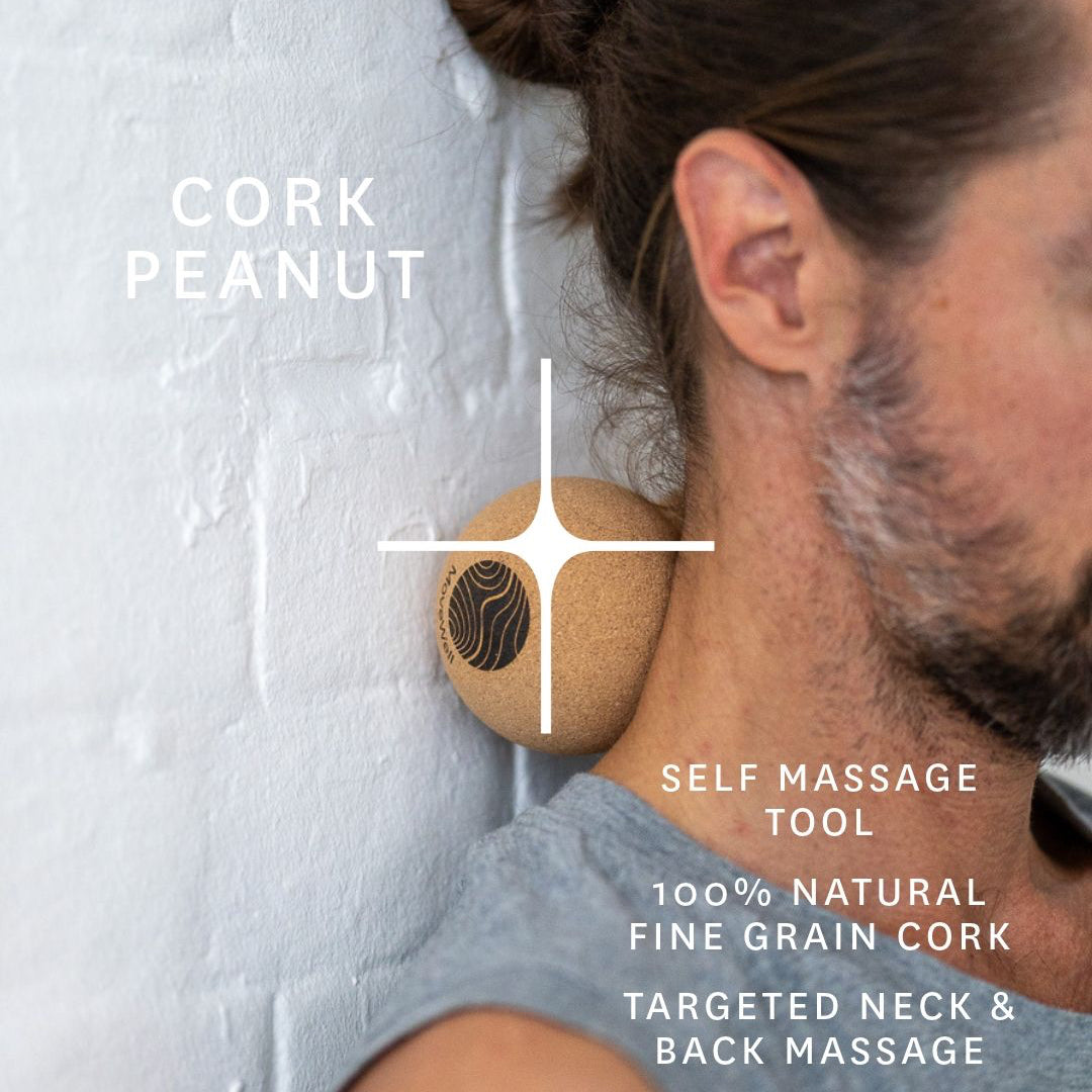 A man with a beard and bun leans his neck against a white textured wall while using a cork massage tool. White text on the image reads 'CORK PEANUT' and 'SELF MASSAGE TOOL 100% NATURAL FINE GRAIN CORK TARGETED NECK & BACK MASSAGE'.